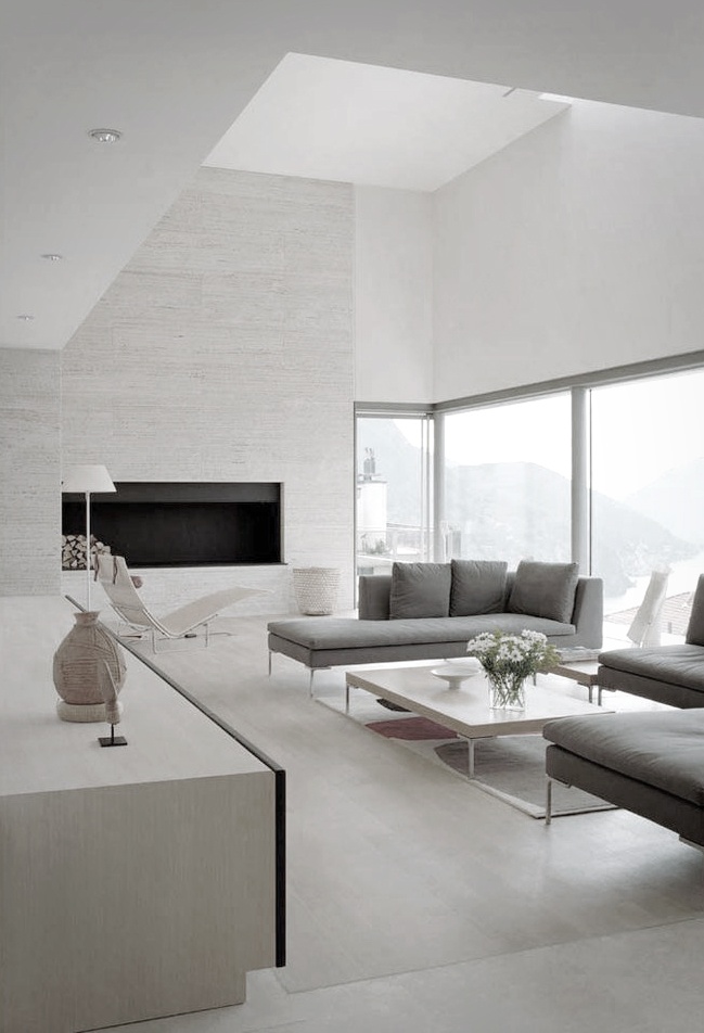 Minimalist white living room - with grey sofas and low coffee table