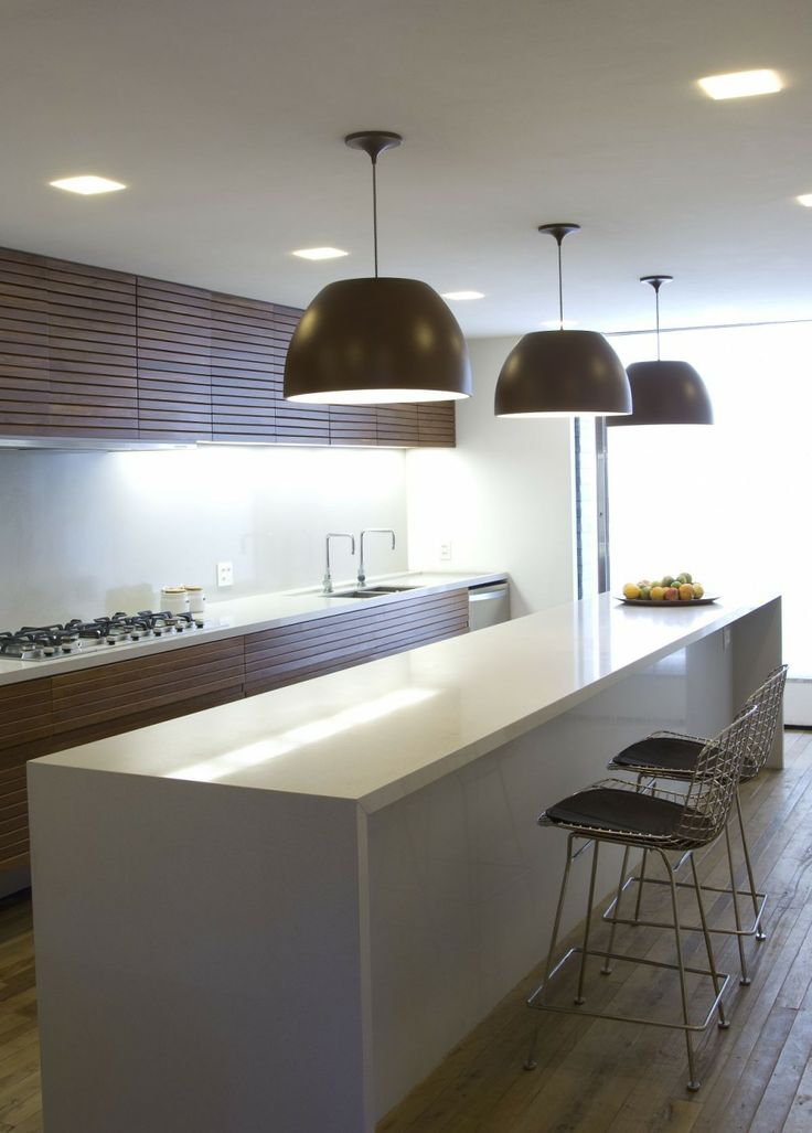 Modern brown and white kitchen - with contemporary pendants over the long island