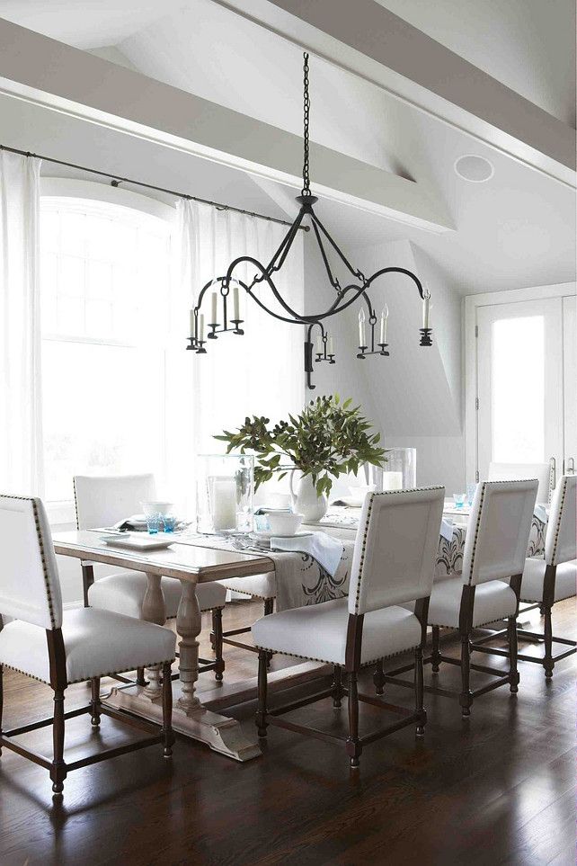 Modern dining room - with white chairs and wood floor