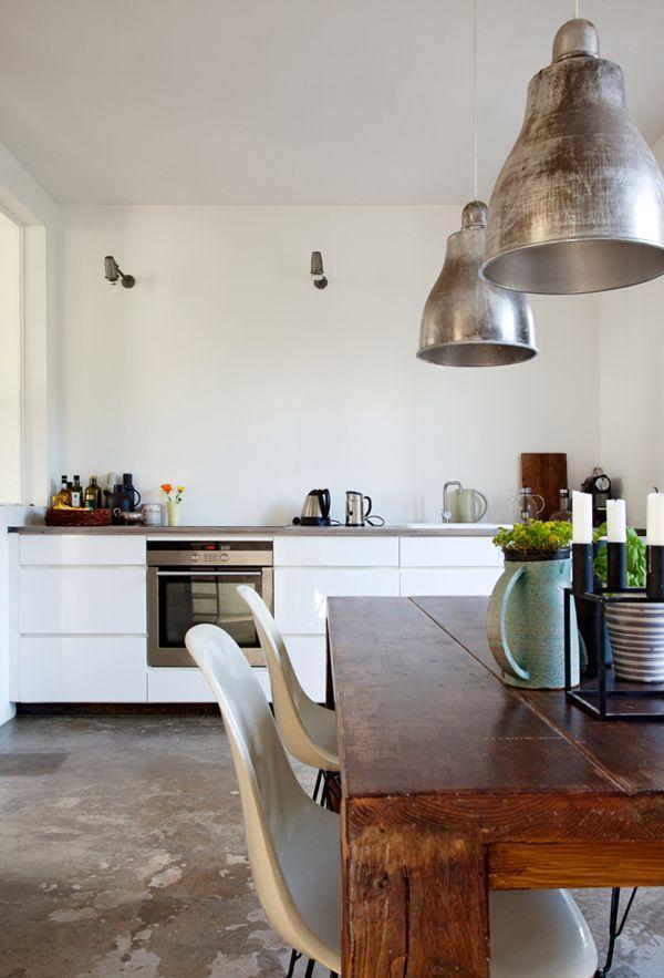 Modern industrial kitchen - with iron pendants and wood table