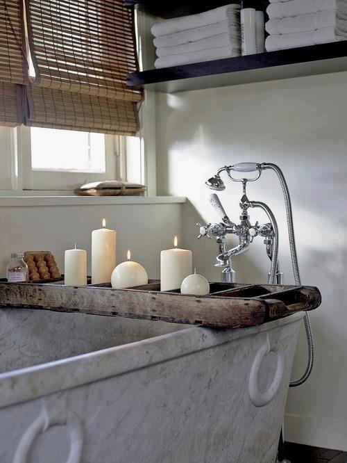 Modern rustic bath with candles - placed on a wooden stand