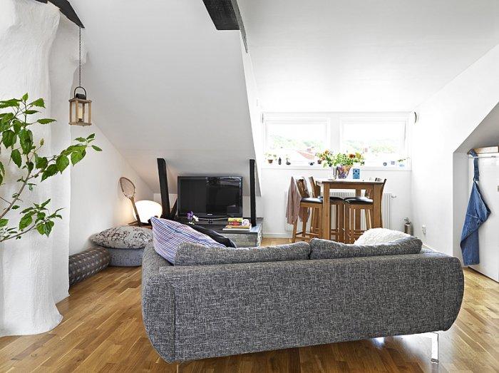 Modern small living room - with grey contemporary sofa and sloped ceiling