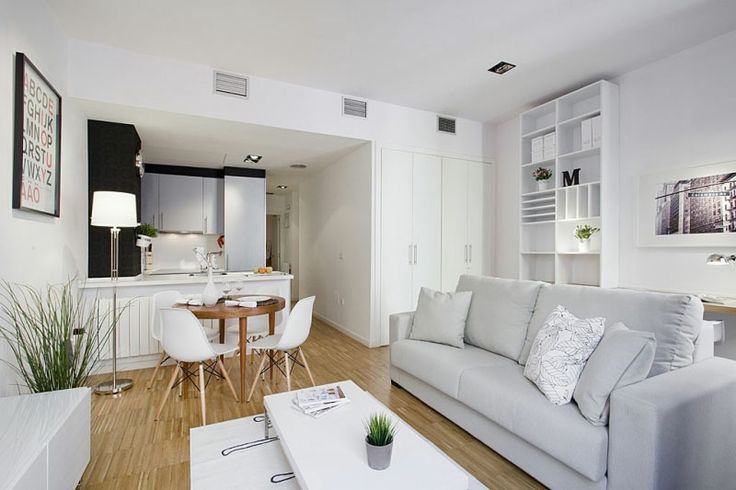 Modern white living room - with small dining table in the background