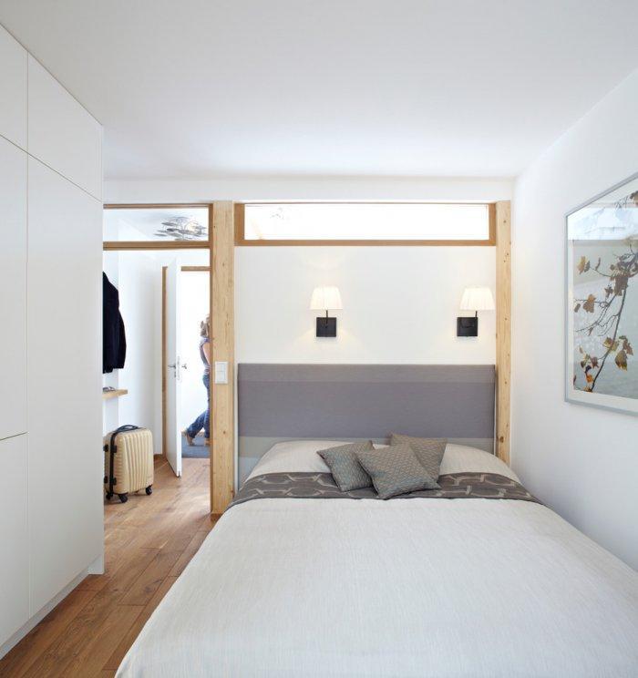 Small apartment bedroom in white - with functional and comfortable bed