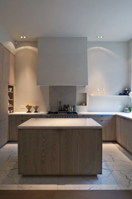 Stylish apartment kitchen - with small island made of wood