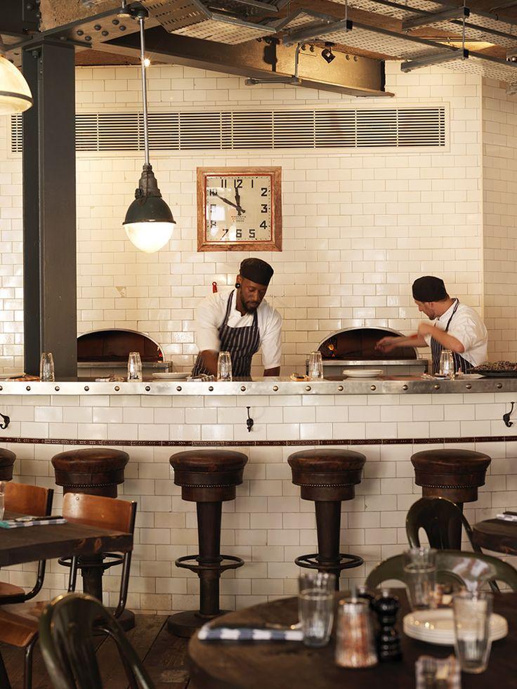 White restaurant kitchen - cooks preparing dishes