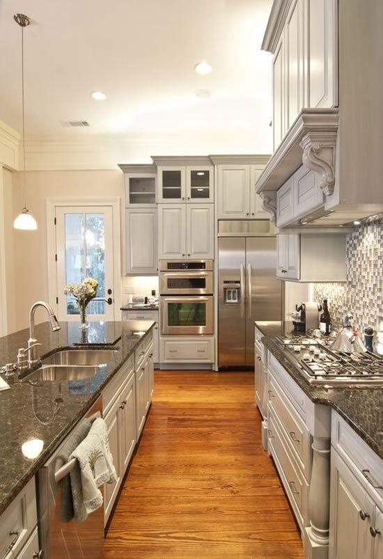 Dark Granite Countertops Used In A White Kitchen Interior