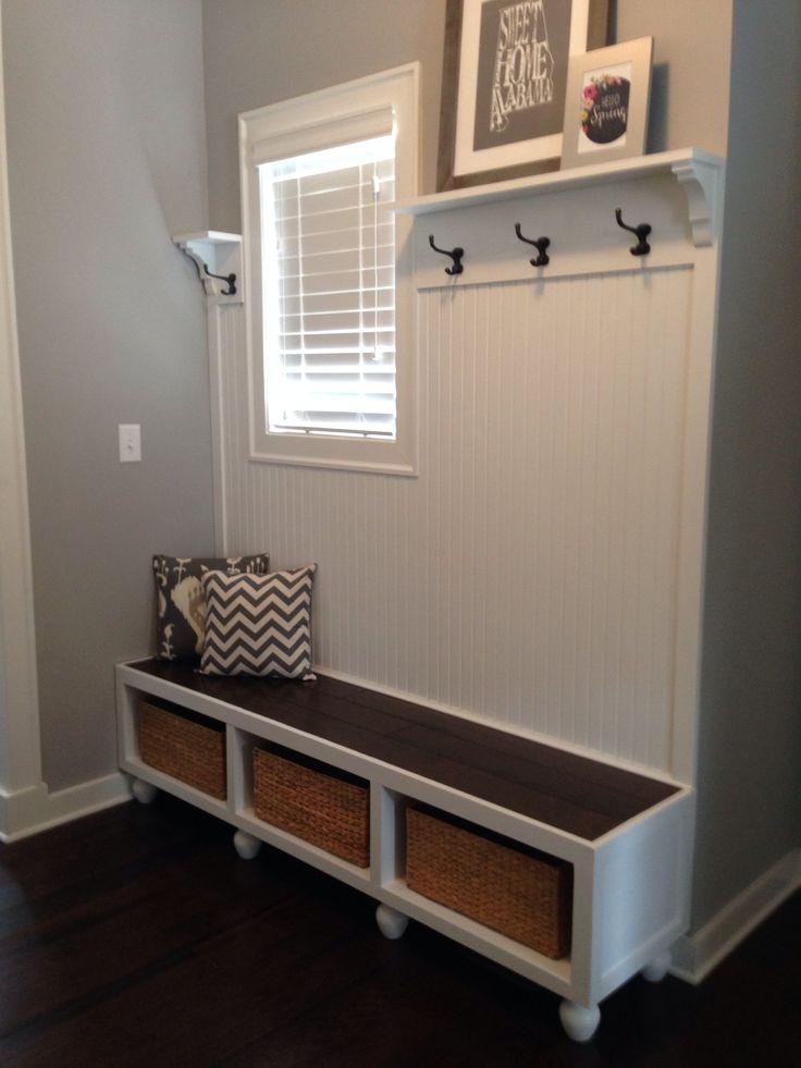 White shelves with basket and hooks - in the entryway